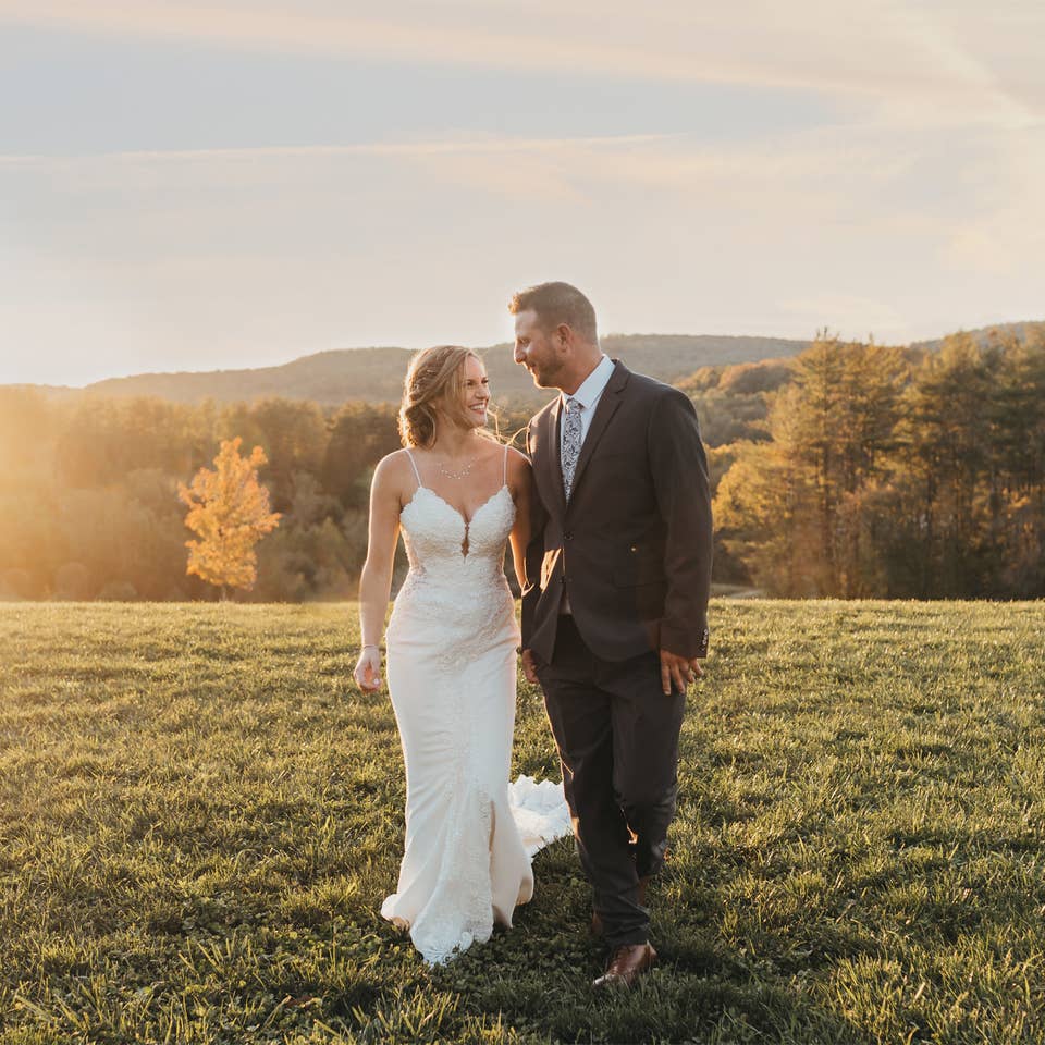 Bride and groom standing on hill after a wedding at Mount Ascutney Resort in Brownsville, Vermont.