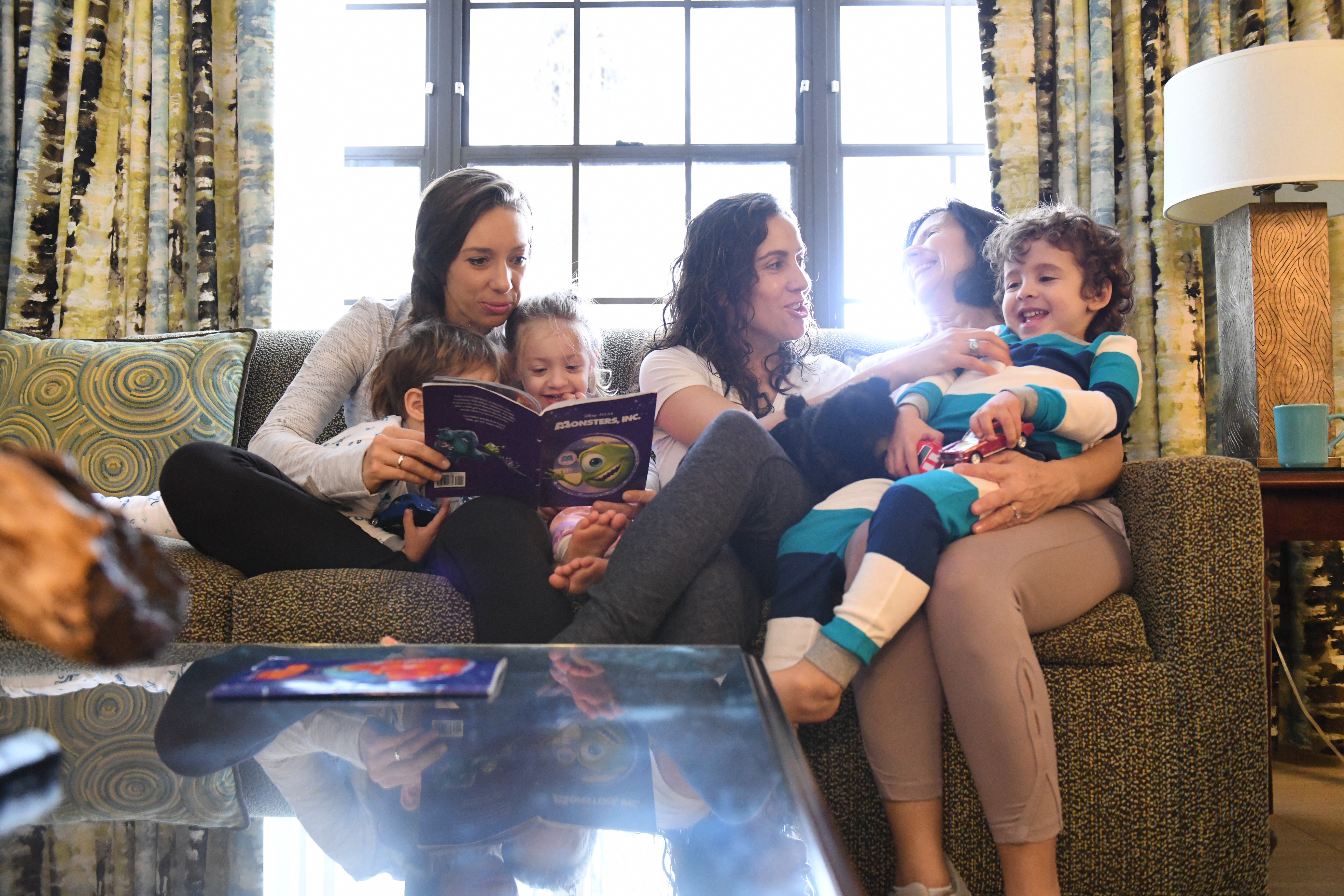 Raff's family reading on the couch in villa