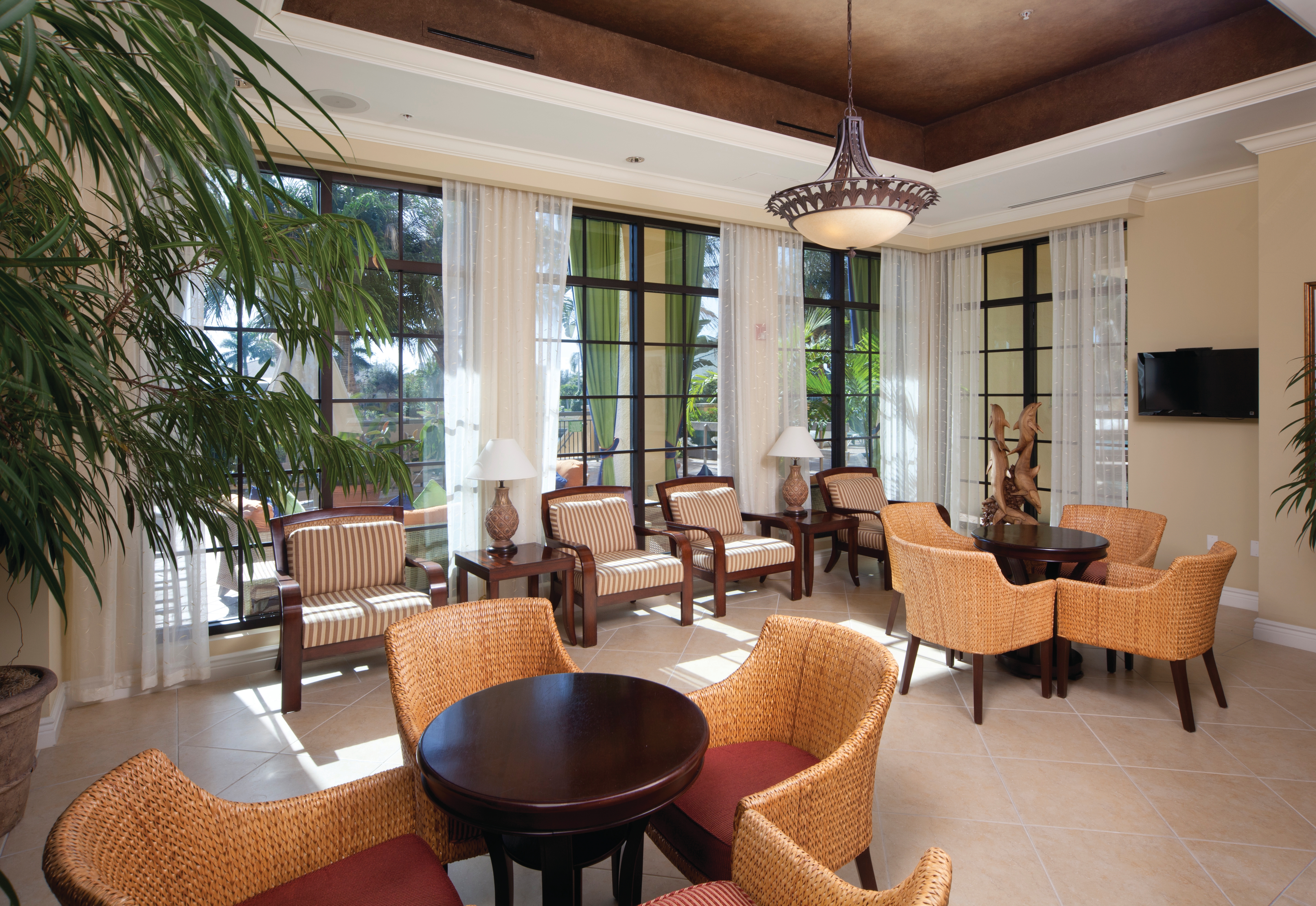 Lounge with comfortable seating and flat screen TV at Sunset Cove Resort in Marco Island, Florida.