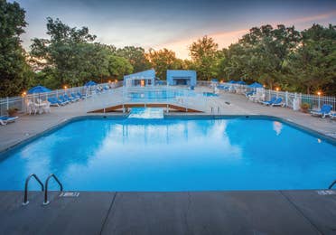 Outdoor pool with sun chairs at Ozark Mountain Resort in Kimberling City, Missouri.