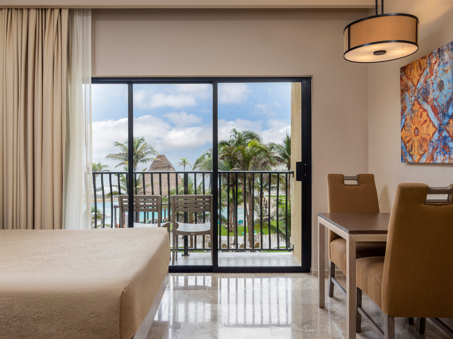 Oceanview room with balcony seating and dining area.