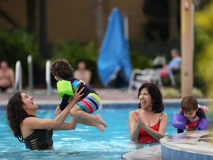 Family enjoying outdoor pool.
