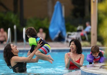 Family enjoying outdoor pool.