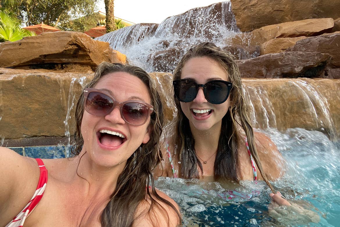 Featured Contributor, Angie Orth (left), and her sister (right) pose next to a water feature at river Island of Orange Lake Resort in Orlando, Florida.