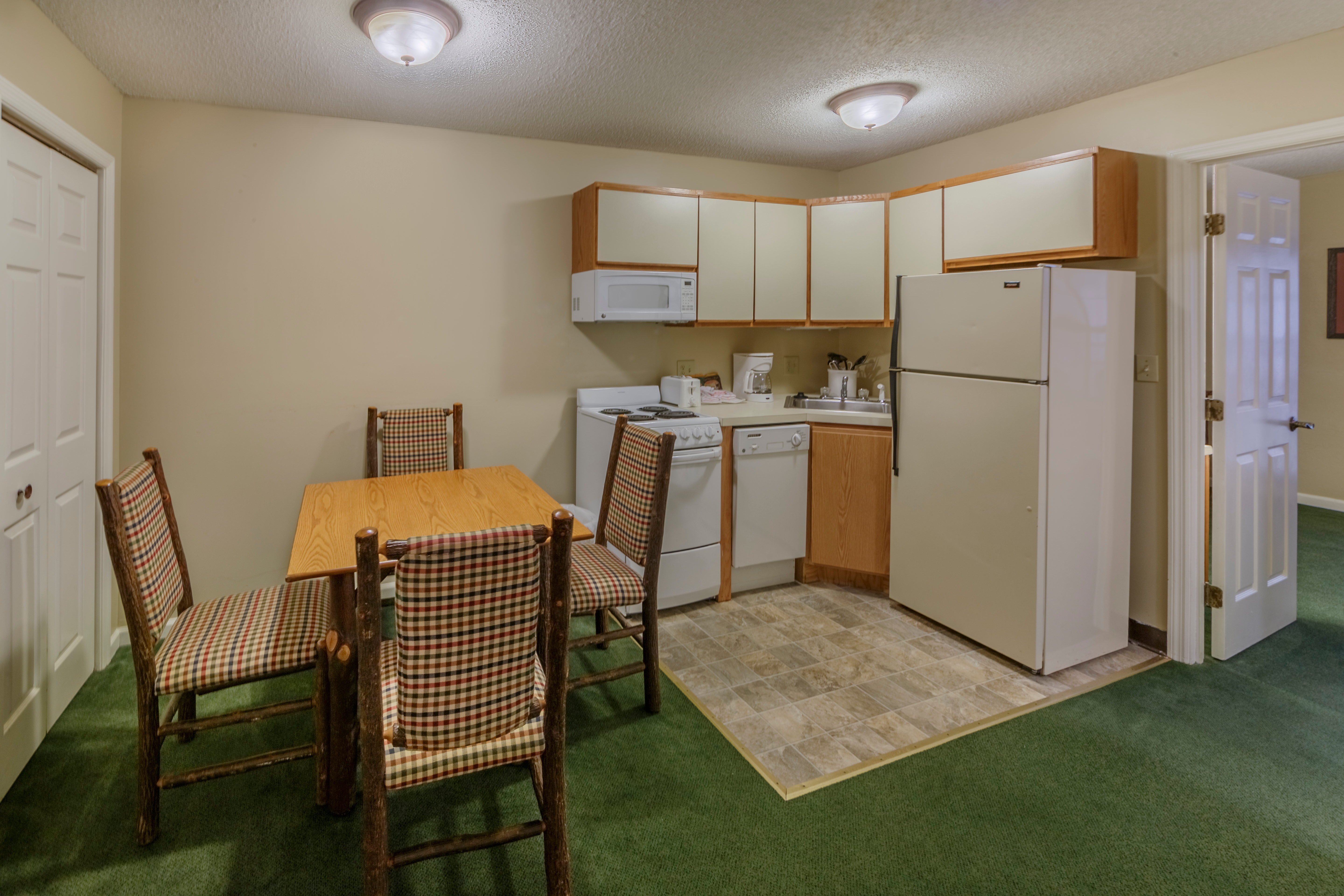 Dining room and kitchen in a three bedroom villa at Oak n' Spruce Resort in South Lee, Massachusetts