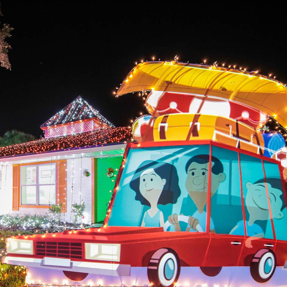 An exterior shot of our HICV villa decorated for the 'Night of a Million Lights' event complete with oversized travel postcards and a family station wagon.