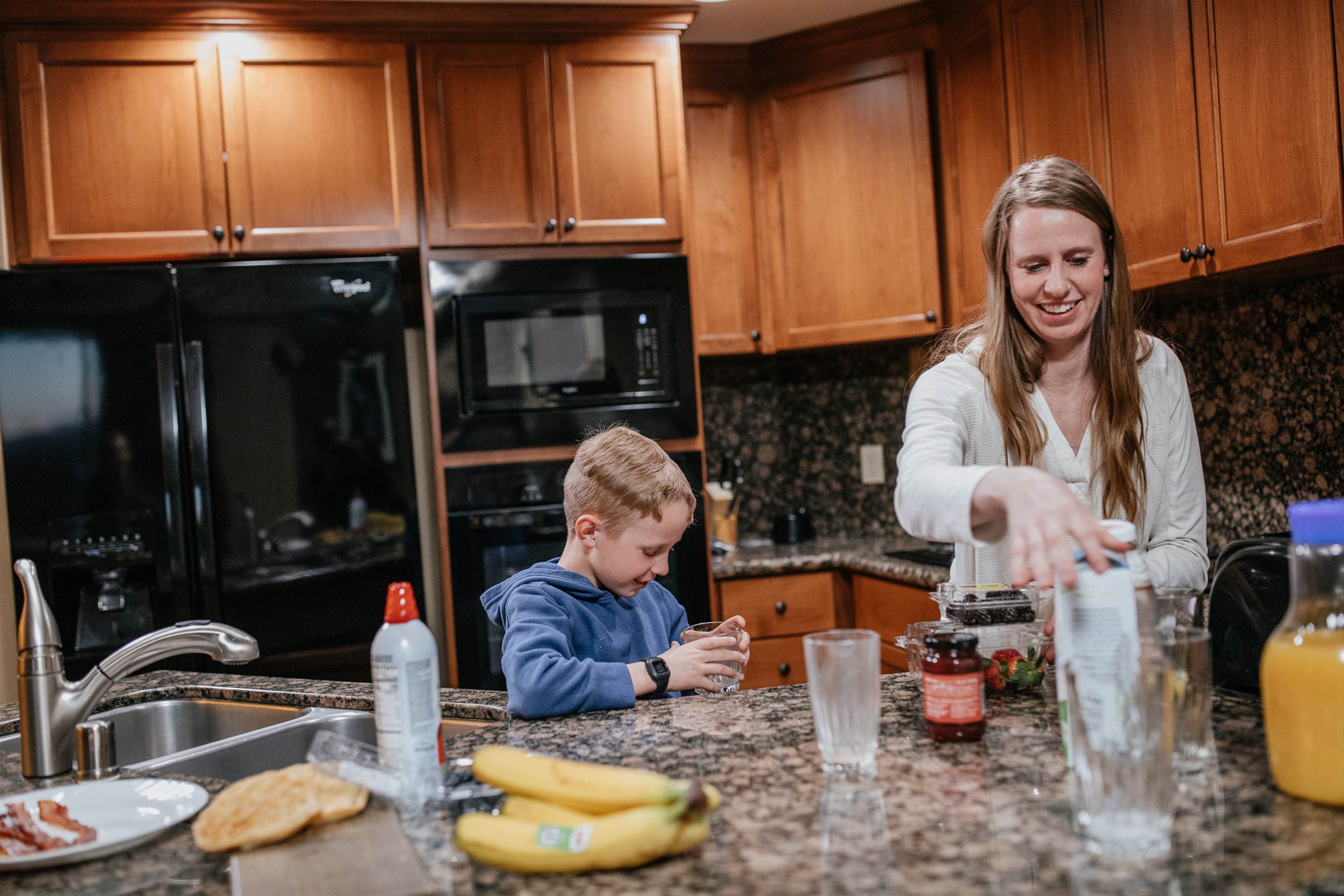 Andrea Rassmussen and her family prep some smoothies in the kitchen