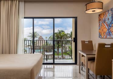 Oceanview room with balcony seating and dining area.
