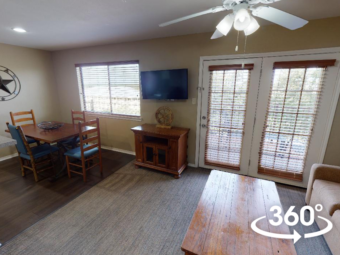 Two-bedroom townhome villa with couch, flat screen TV and dining area at Hill Country Resort in Canyon Lake, Texas.