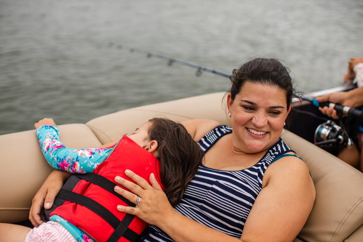 Angelica cuddling with her daughter on the boat