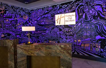 A mural with animated projection mapping in various colors of purple, orange, yellow and magenta featured in the lobby of our resort in New Orleans, Louisiana.