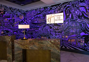A mural with animated projection mapping in various colors of purple, orange, yellow and magenta featured in the lobby of our resort in New Orleans, Louisiana.