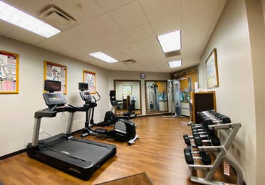 Fitness center with a treadmill, stationary bicycle, elliptical and free weights at Smoky Mountain Resort in Gatlinburg, Tennessee.