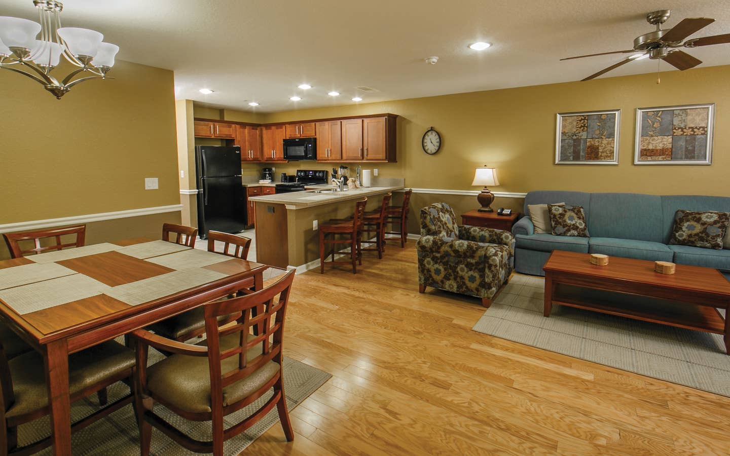Living, kitchen and dining areas in a villa at Orlando Breeze Resort.