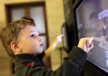 Child playing on interactive screen at Wonder Works near Panama City Beach Resort.