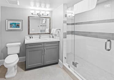 Bathroom with walk-in shower in a four-bedroom Signature Collection villa at Cape Canaveral Resort.