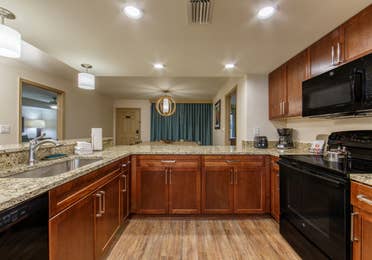 Full kitchen with dishwasher, fridge, oven, microwave, and sink in a three-bedroom villa at Scottsdale Resort