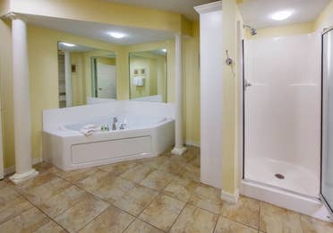 Bathroom with walk-in shower and large bathtub in a Presidential two-bedroom villa at Ozark Mountain Resort in Kimberling City, Missouri