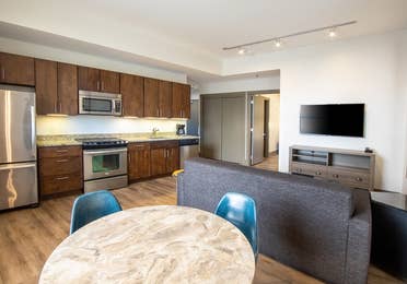 One bedroom villa living room with full kitchen, dining area, couch and TV at New Orleans Resort in Louisiana.