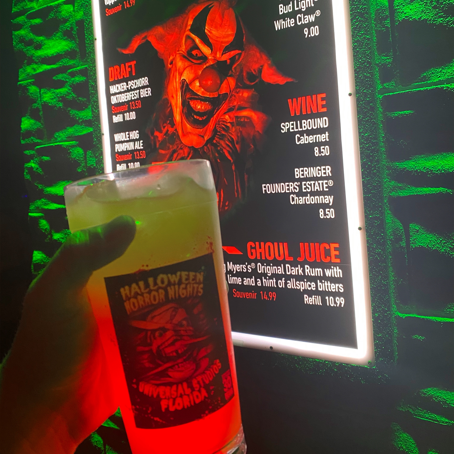 A mixed cocktail drink in a Halloween-themed glass.