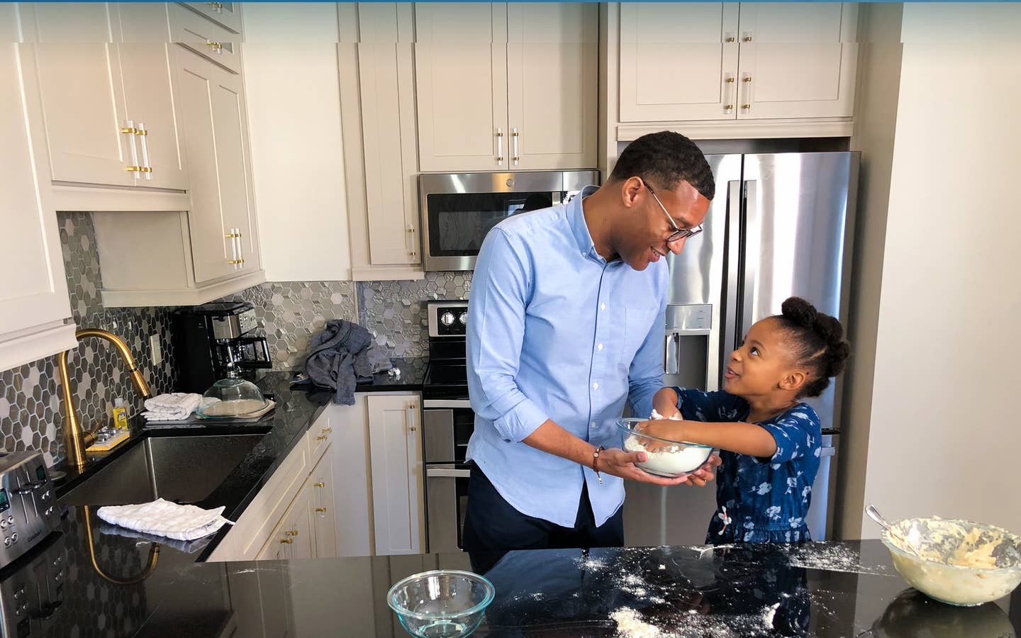 Father and daughter baking in a villa at New Orleans Resort in Louisiana.