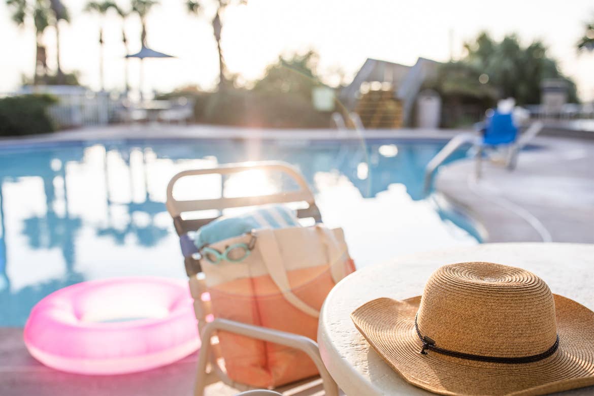 Jennifer's hat sits on a table with swimwear next to the poolside of a Holiday Inn Club Vacation Resort.