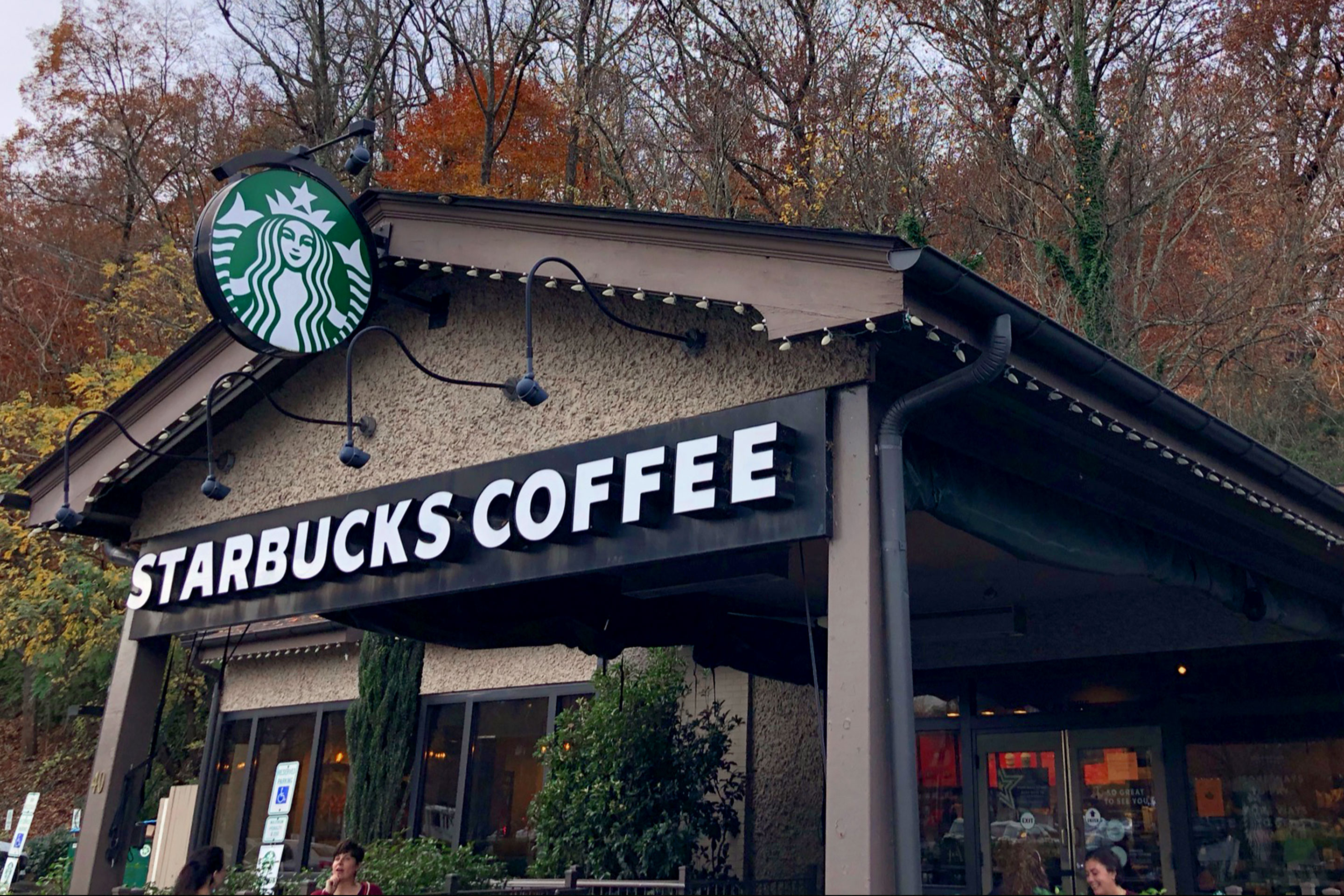 The exterior of a local Starbucks near the Biltmore Estate with signage that reads, 'Starbucks Coffee.'