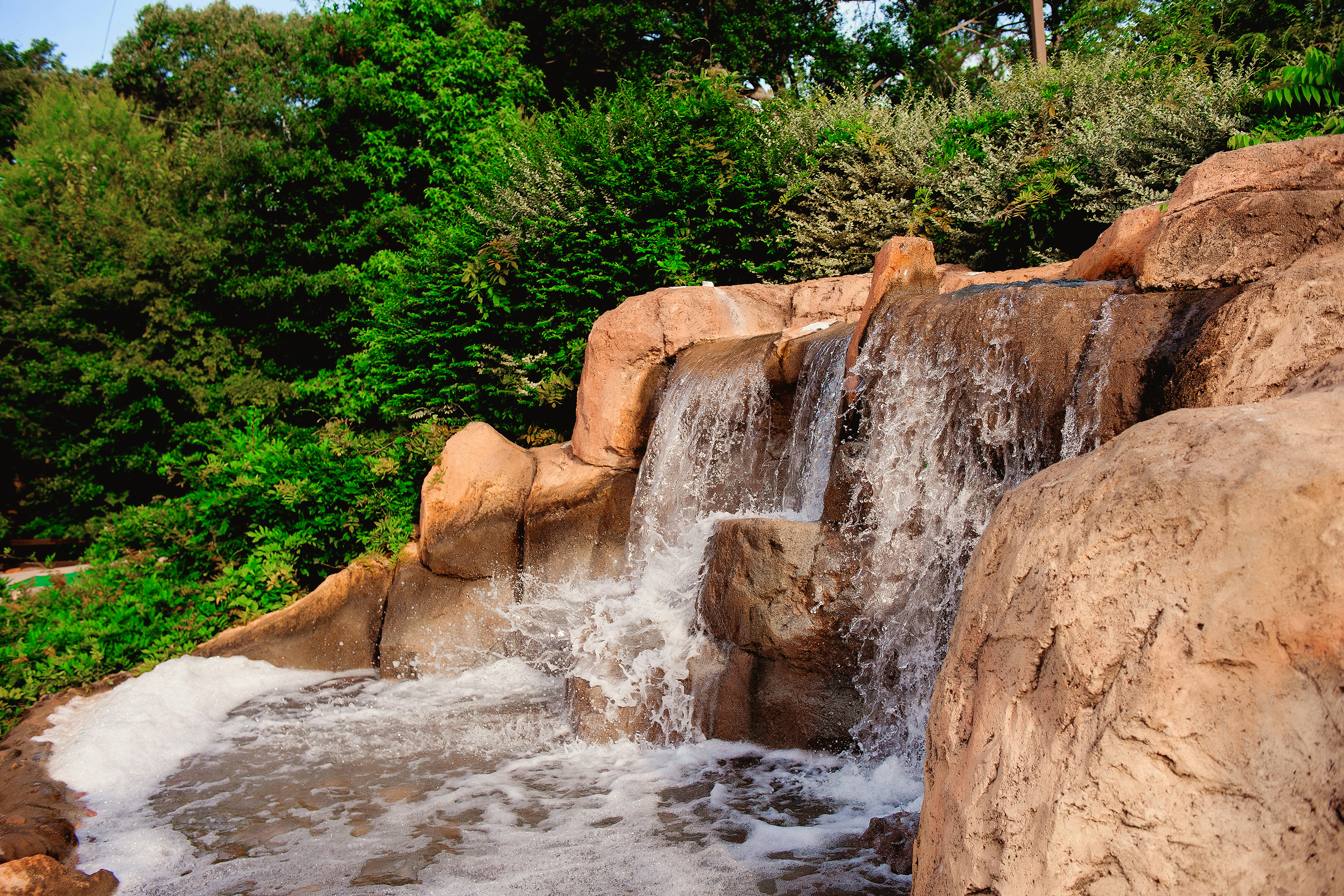 A waterfall feature and various putting greens at our mini golf course at Villages Resort in Flint, Texas.