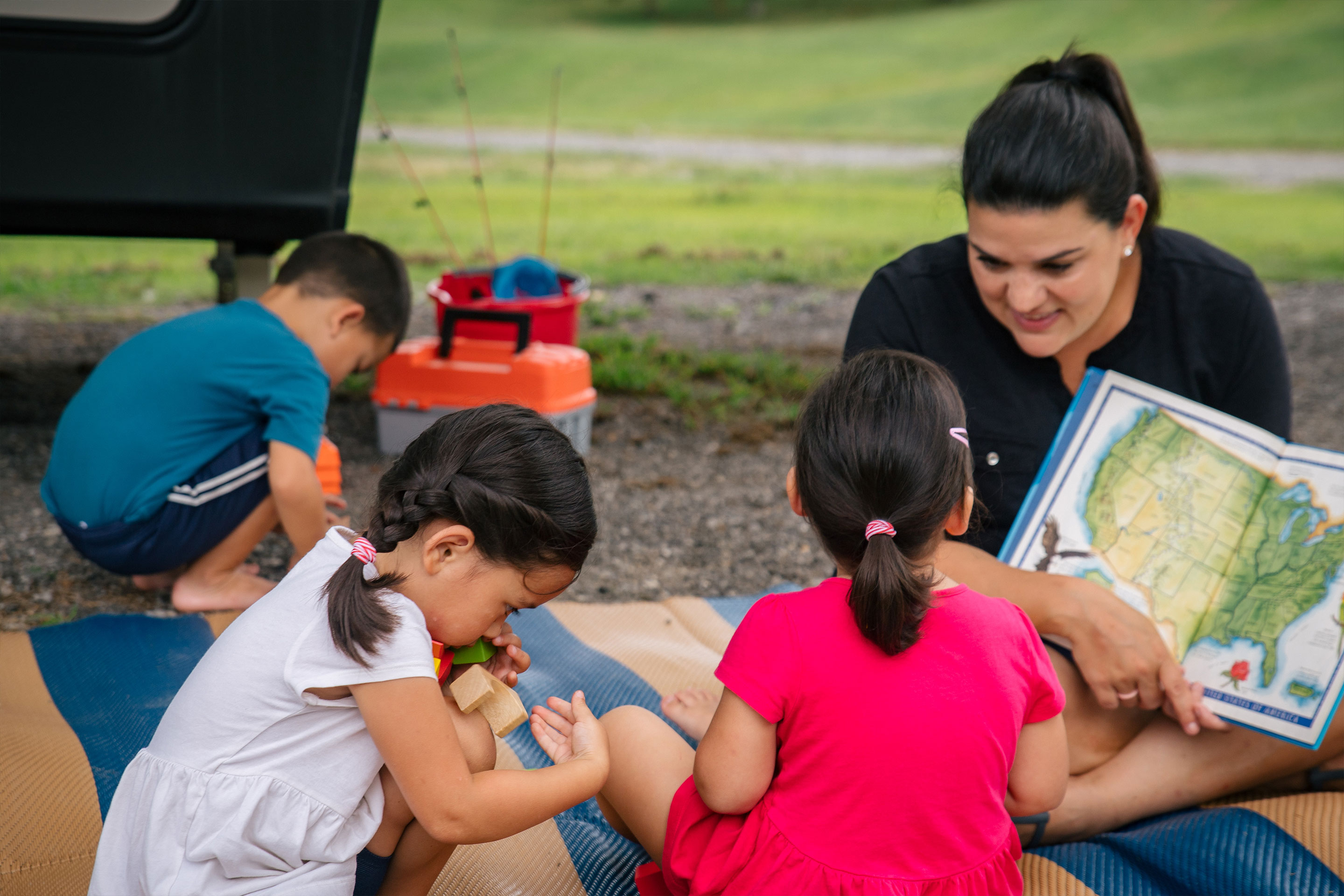 Angelica (right) homeschools her children outside of the RV.