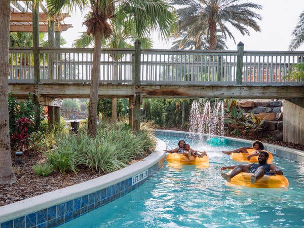 Three guests floating down lazy river at Orange Lake Resort near Orlando, Florida.