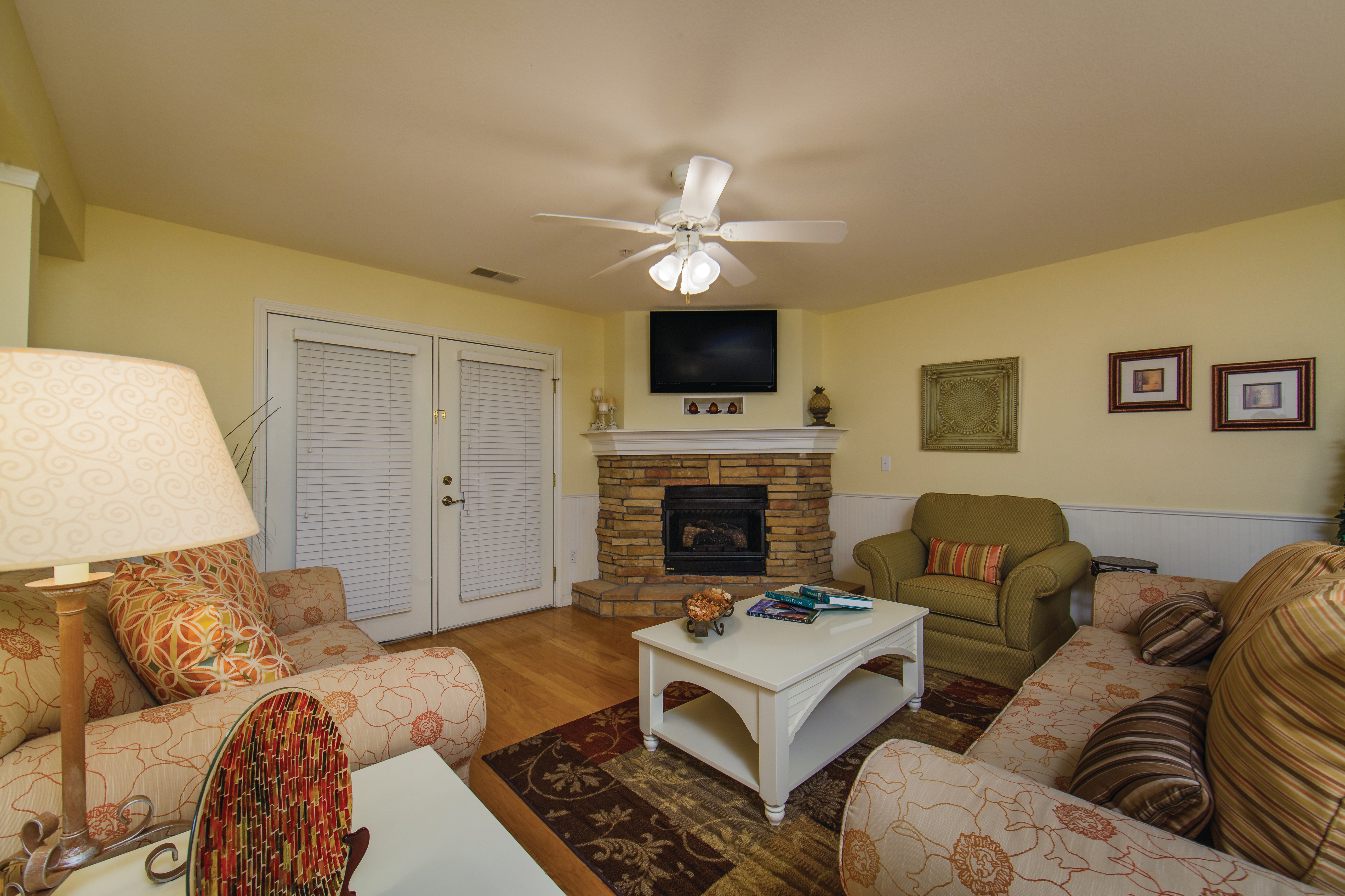 Living room with fireplace and TV in a two-bedroom presidential villa at the Holiday Hills Resort in Branson Missouri.