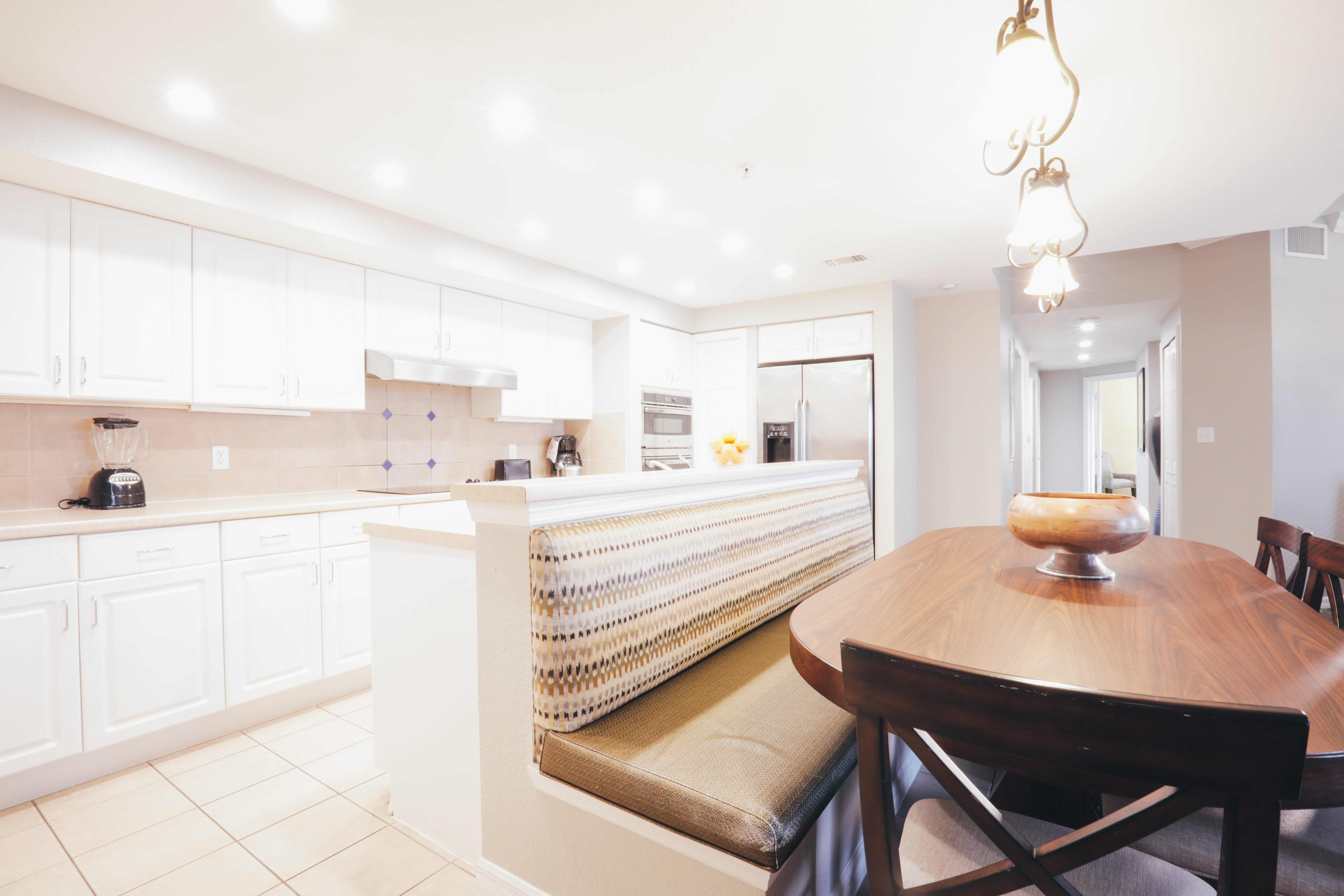 Dining area and full kitchen in background in villa in River Island at Orange Lake Resort near Orlando, Florida