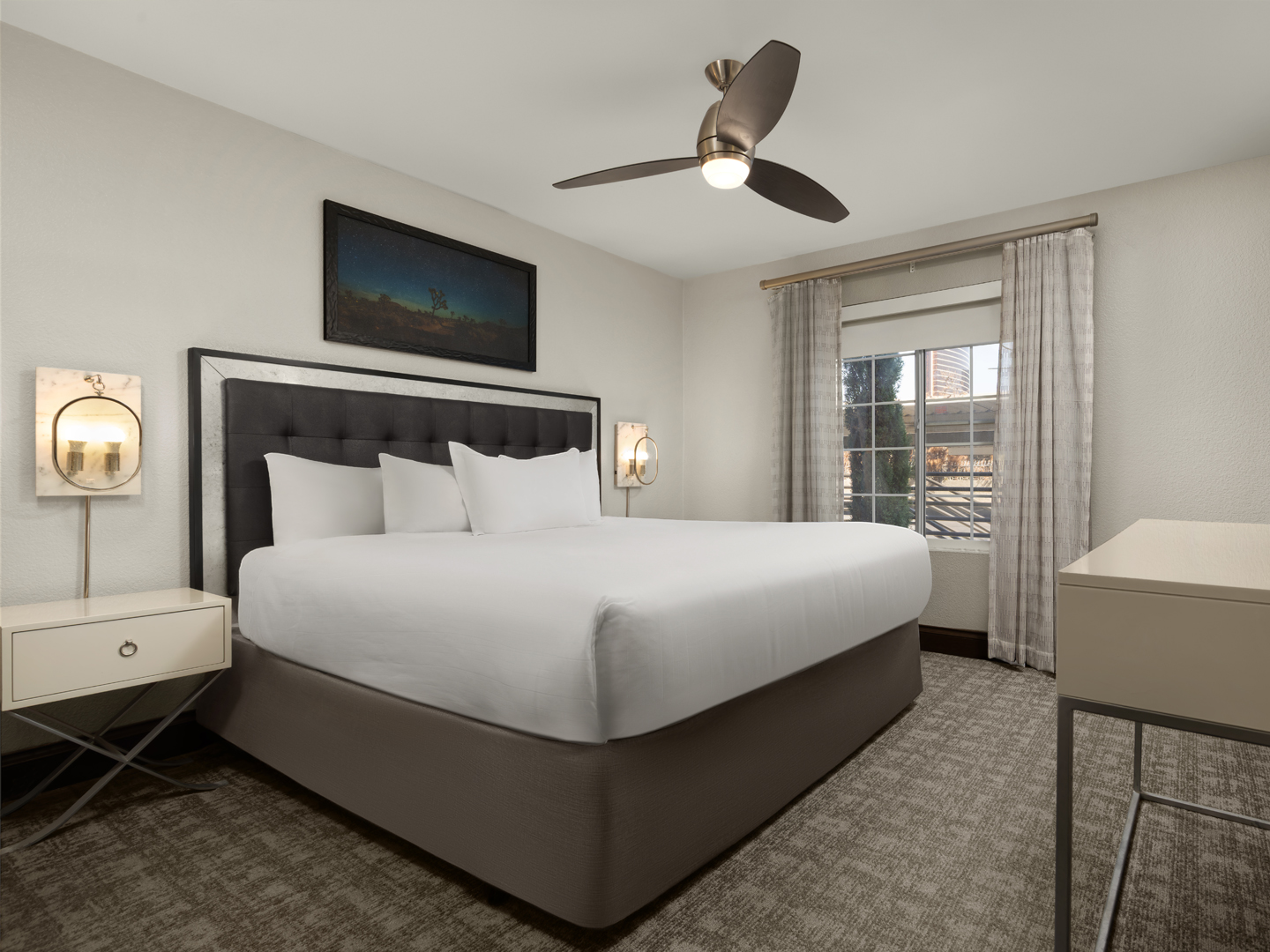 Stylish bedroom with elegant lighting and a plush king bed.
