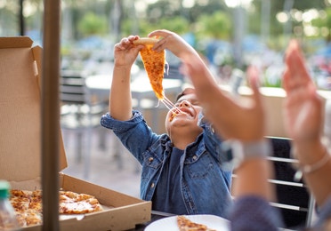 Young boy eating pizza at Orange Lake Resort near Orlando, Florida