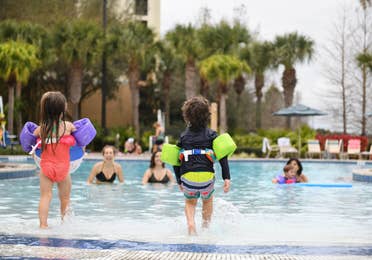 Young children entering swimming pool at Orange Lake Resort near Orlando, Florida