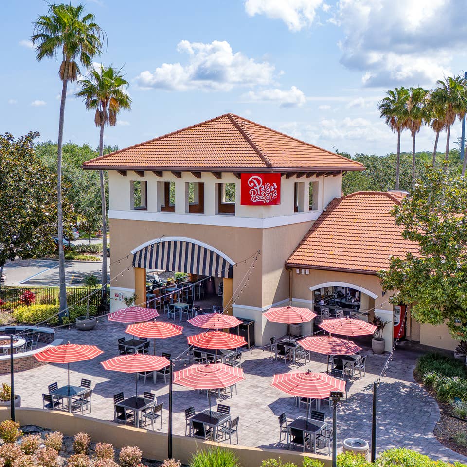 A group of people eating outside of Paisan Pizzeria at Orange Lake Resort near Orlando, Florida.