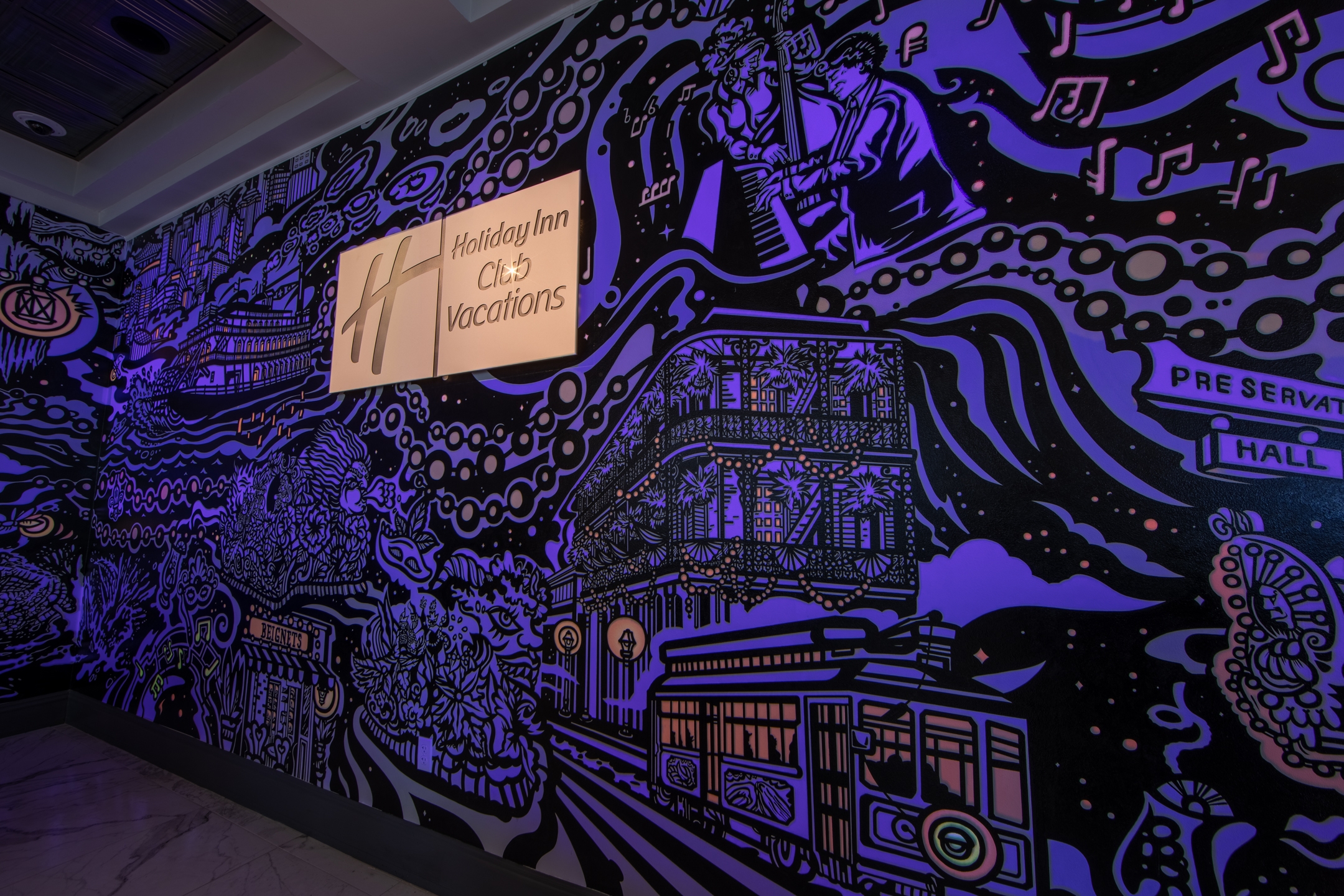 Closeup view of Holiday Inn Club Vacations sign on mural at New Orleans Resort in Louisiana.