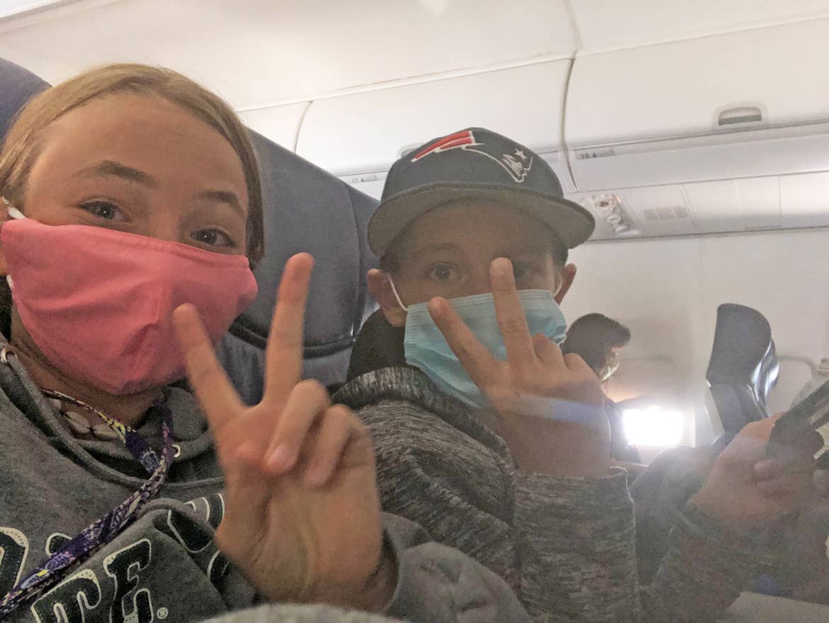 Ashley's kids taking a selfie on the plane