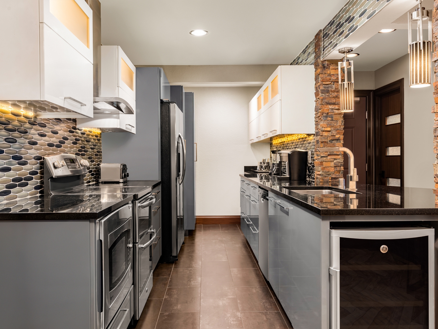 Chic, modern kitchen and dining area with stone accents.
