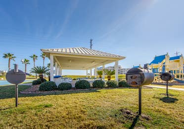A gazebo surrounded by grills in the picnic area at Galveston Seaside Resort.