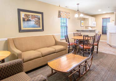 Living room, dining and kitchen area in a two-bedroom lodge villa at Fox River Resort in Sheridan, Illinois.