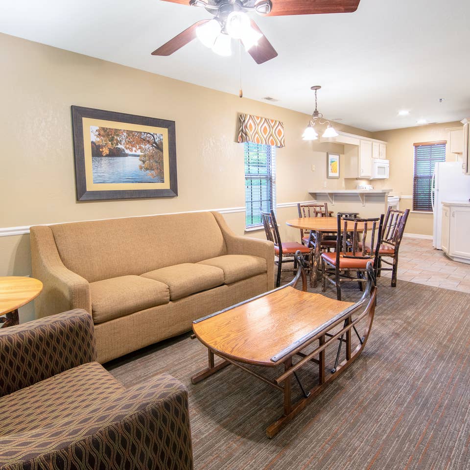 Living room, dining and kitchen area in a two-bedroom lodge villa at Fox River Resort in Sheridan, Illinois.