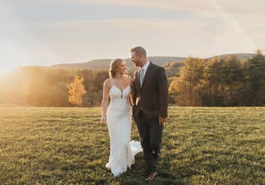 Bride and groom standing on hill after a wedding at Mount Ascutney Resort in Brownsville, Vermont.
