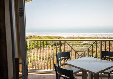 Balcony with table and chairs in a two-bedroom villa at Cape Canaveral Beach Resort.