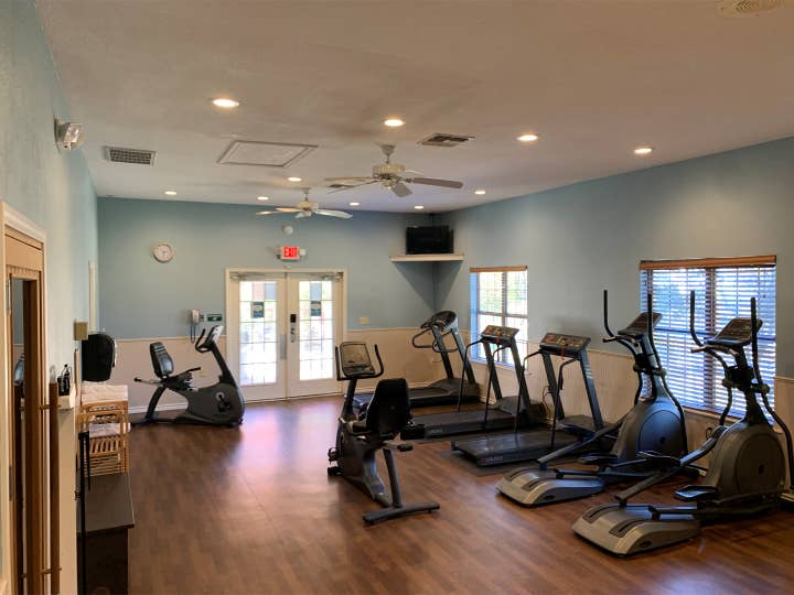 Fitness center at Villages Resort with treadmills, ellipticals and stationary bikes.