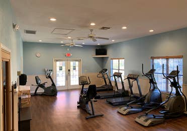 Fitness center at Villages Resort with treadmills, ellipticals and stationary bikes.