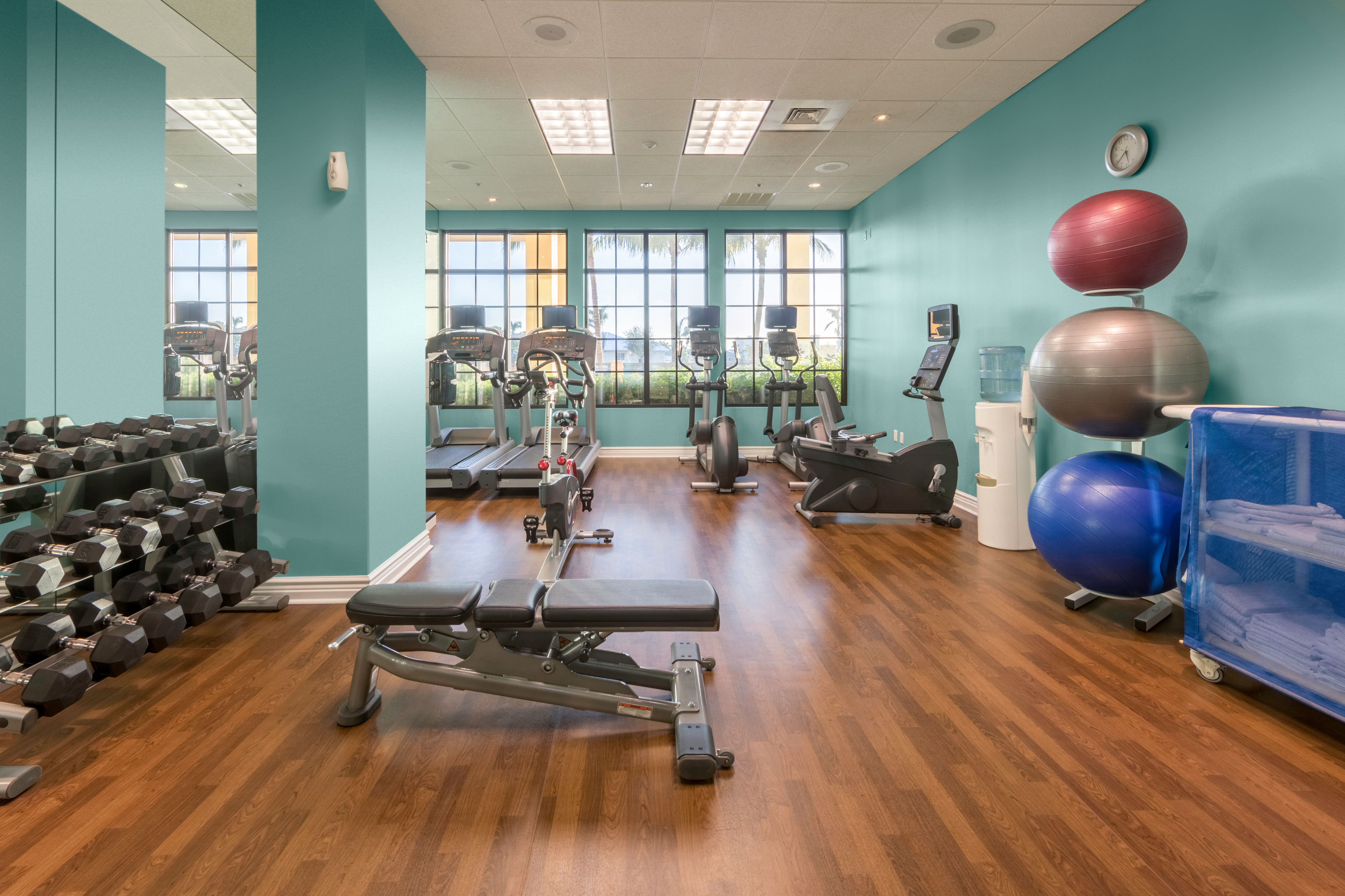 Fitness center with yoga balls, free weights, treadmills, and elliptical machines at Sunset Cove Resort in Marco Island, Florida.