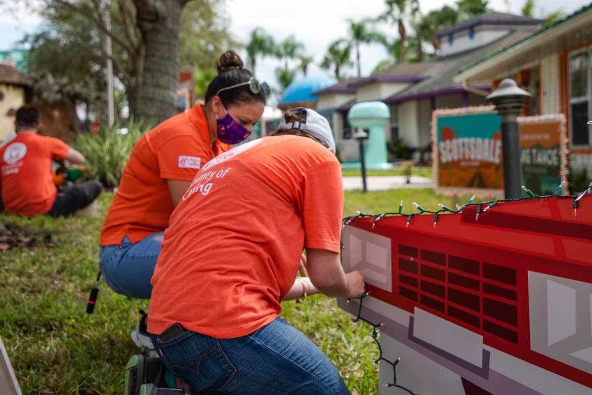 HICV team members help to set up the Company's villa for the holiday event Night of a Million Lights at Give Kids The World Village.