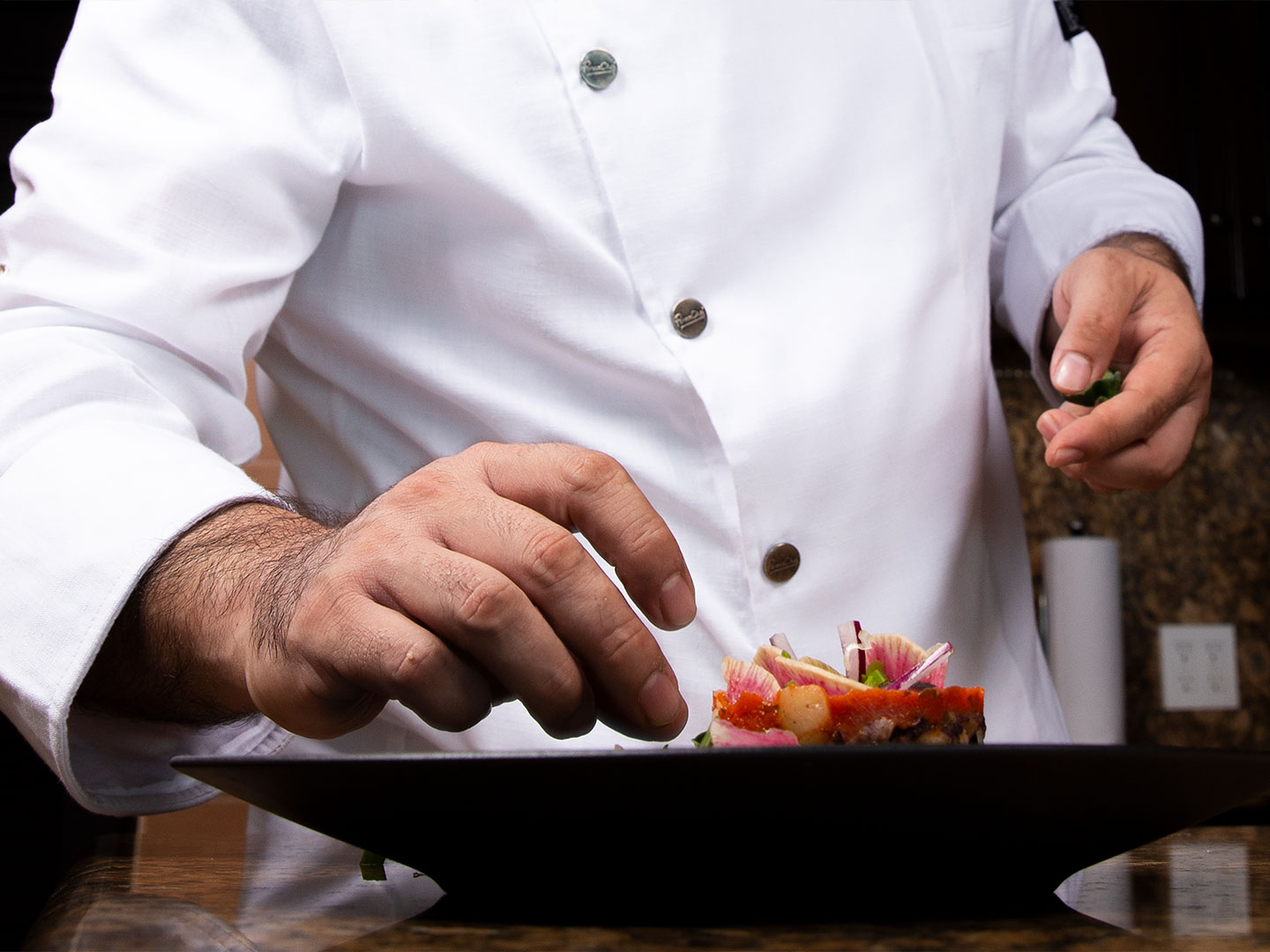 Chef making the final touch at the Grand Residences Resort in Puerto Morelos, Mexico