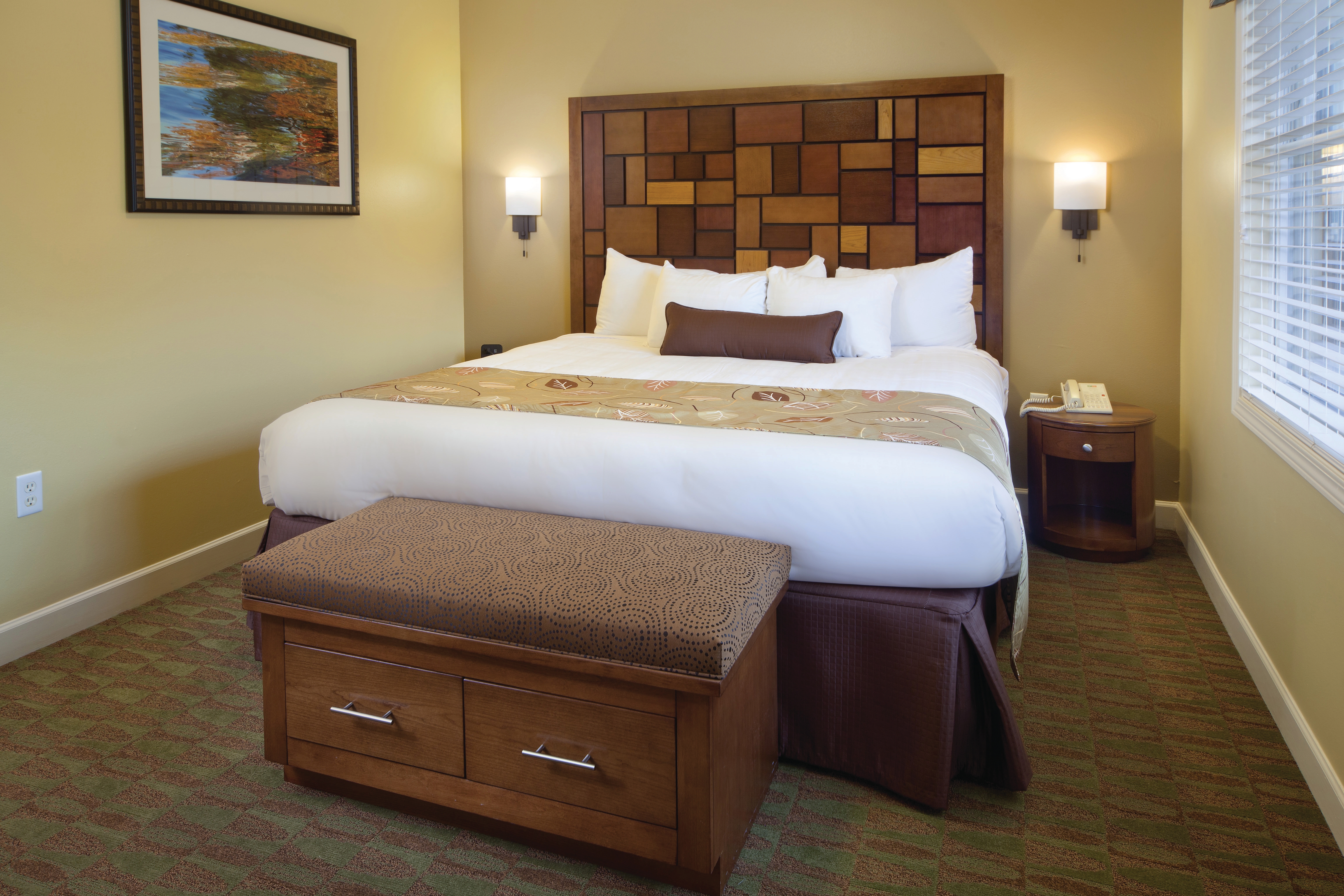 Master bedroom with king bed and large window in a villa at Lake Geneva Resort